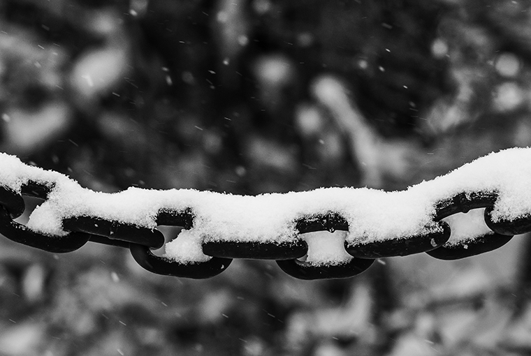 Chain links with snow on them