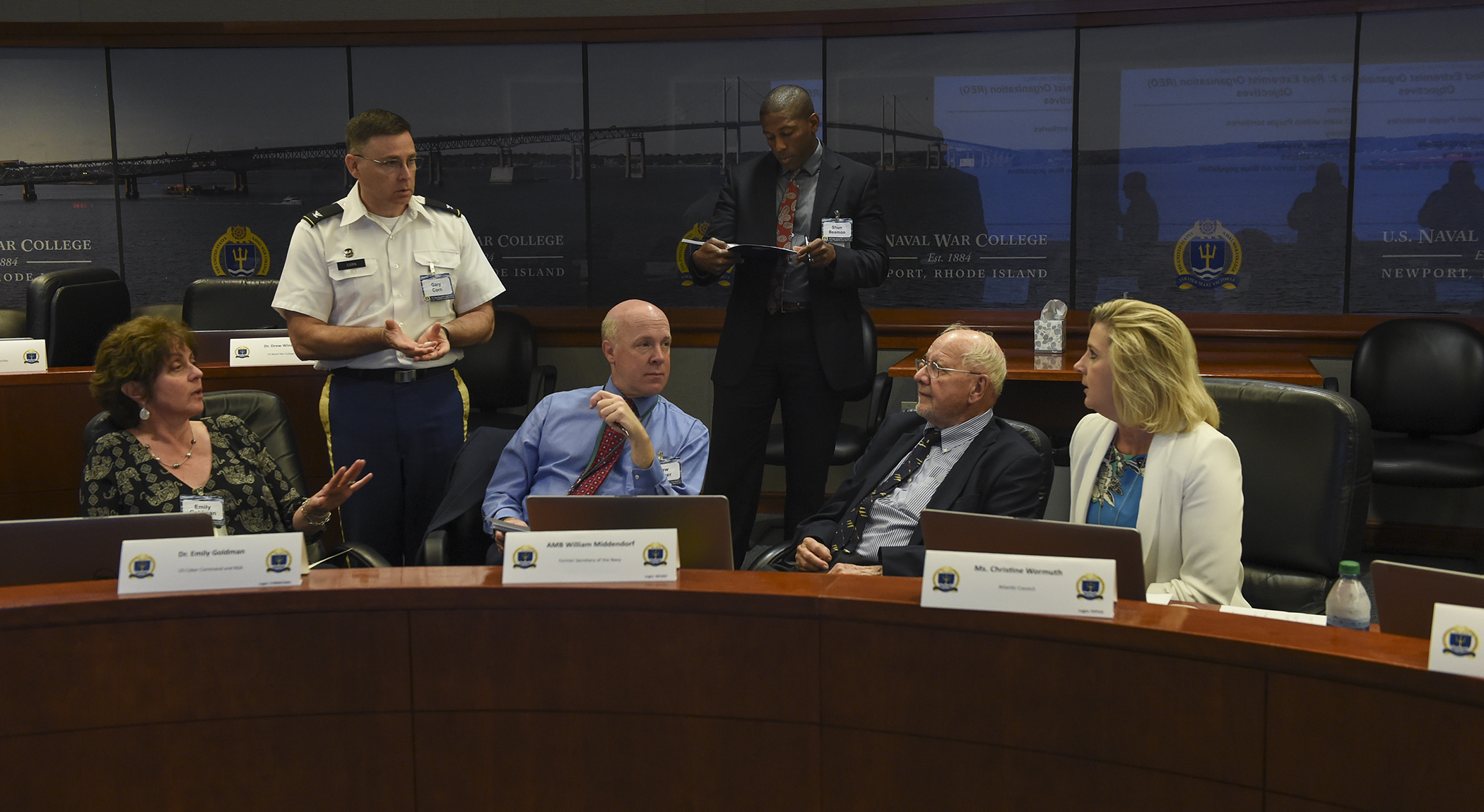 Participants discuss an evolving situation as part of the Navy-Private Sector Critical Infrastructure Wargame held at U.S. Naval War College (NWC), Newport, Rhode Island.