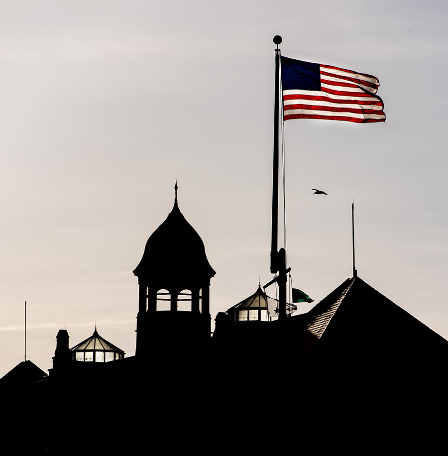 U.S. Naval War College with American flag waving during sunset