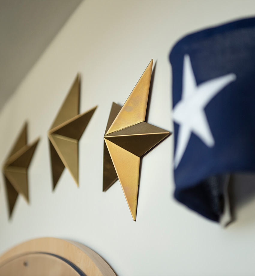 Stars hanging on a wall with a flag.