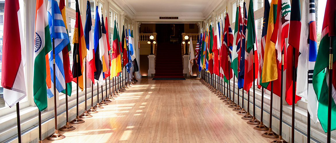 Pringle Hall with international flags at the U.S. Naval War College.