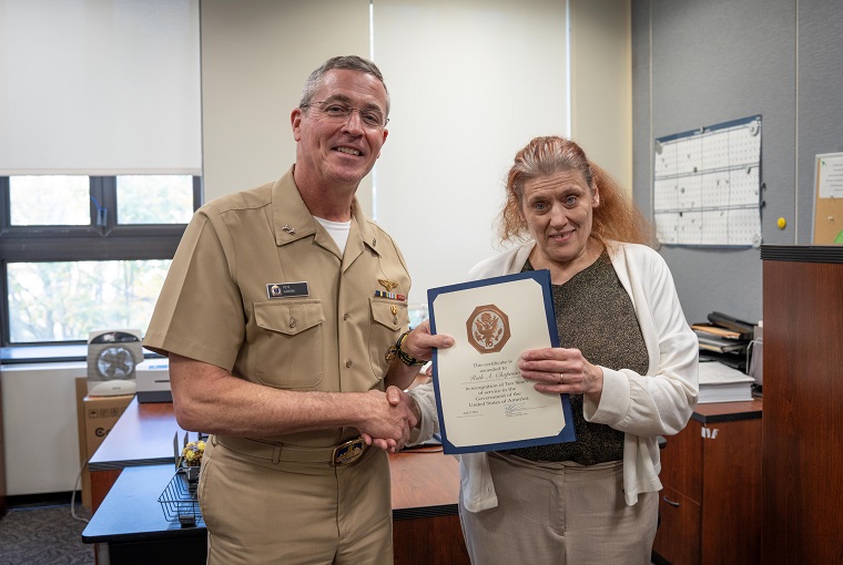 Rear Adm. Pete Garvin awarding Mrs. Ruth Chapman for 10 years of federal civilian service
