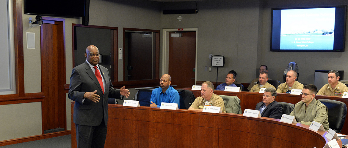 William Bundy, director of U.S. Naval War College's (NWC) Gravely Naval Warfare Research Group, speaks with participants of the Unmanned Systems Workshop held at NWC in Newport, Rhode Island. 