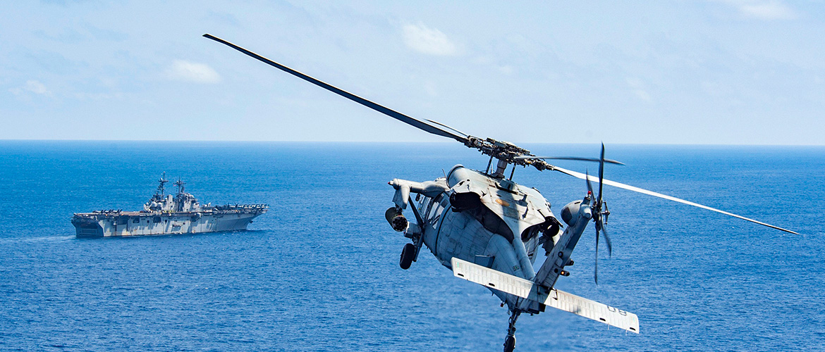 An MH-60S Sea Hawk attached to Helicopter Sea Combat Squadron 25 (HSC-25) approaches the amphibious assault ship USS Wasp (LHD 1). 