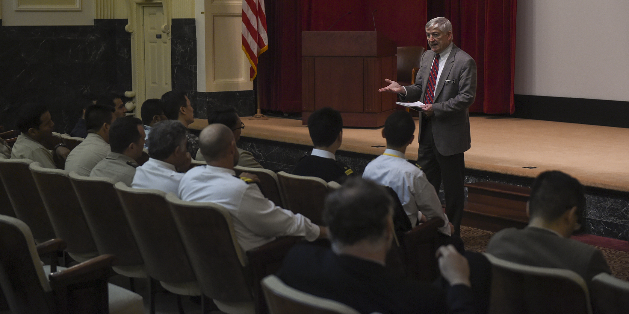 James Kelly, retired Navy rear admiral and dean of U.S. Naval War College’s (NWC) College of Operational and Strategic Leadership, gives a presentation to international NWC students attending a newly designed International Maritime Staff Operators Course (I-MSOC) held in NWC’s Pringle Auditorium. 
