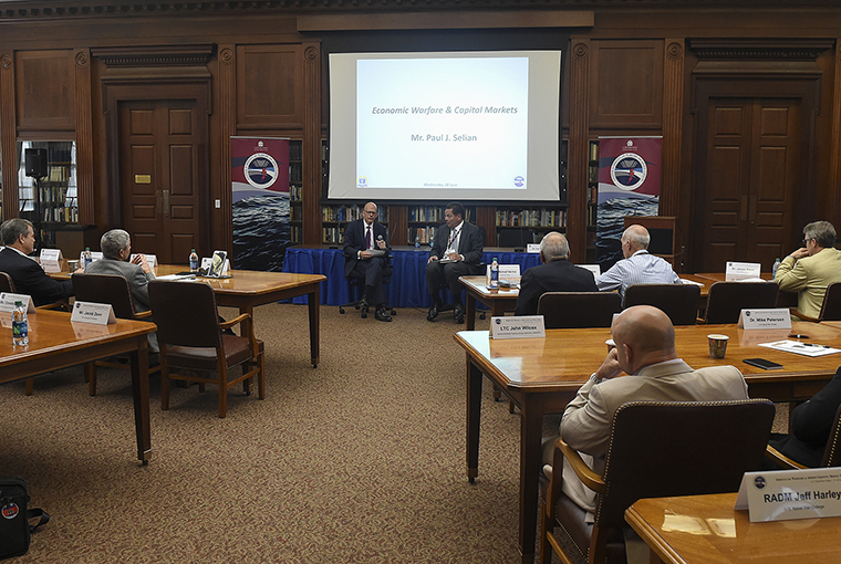  Paul Selian, State Street Corporation, (left), with moderator Thomas Sass, addresses a symposium hosted by the Center for Irregular Warfare and Armed Groups (CIWAG) at the school in Newport, Rhode Island.