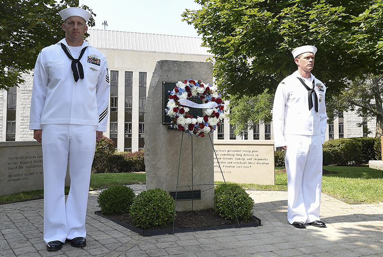 Chief Hospital Corpsman (select) Christopher Van Gelder, assigned to Naval Health Clinic New England; and Chief Navy Career Counselor (select) Anthony Wager, assigned to Surface Warfare Officers School, stand next to a wreath at U.S. Naval War College’s (NWC) Patriots Memorial during a ceremony to commemorate the 16th anniversary of the 9/11 attacks. 