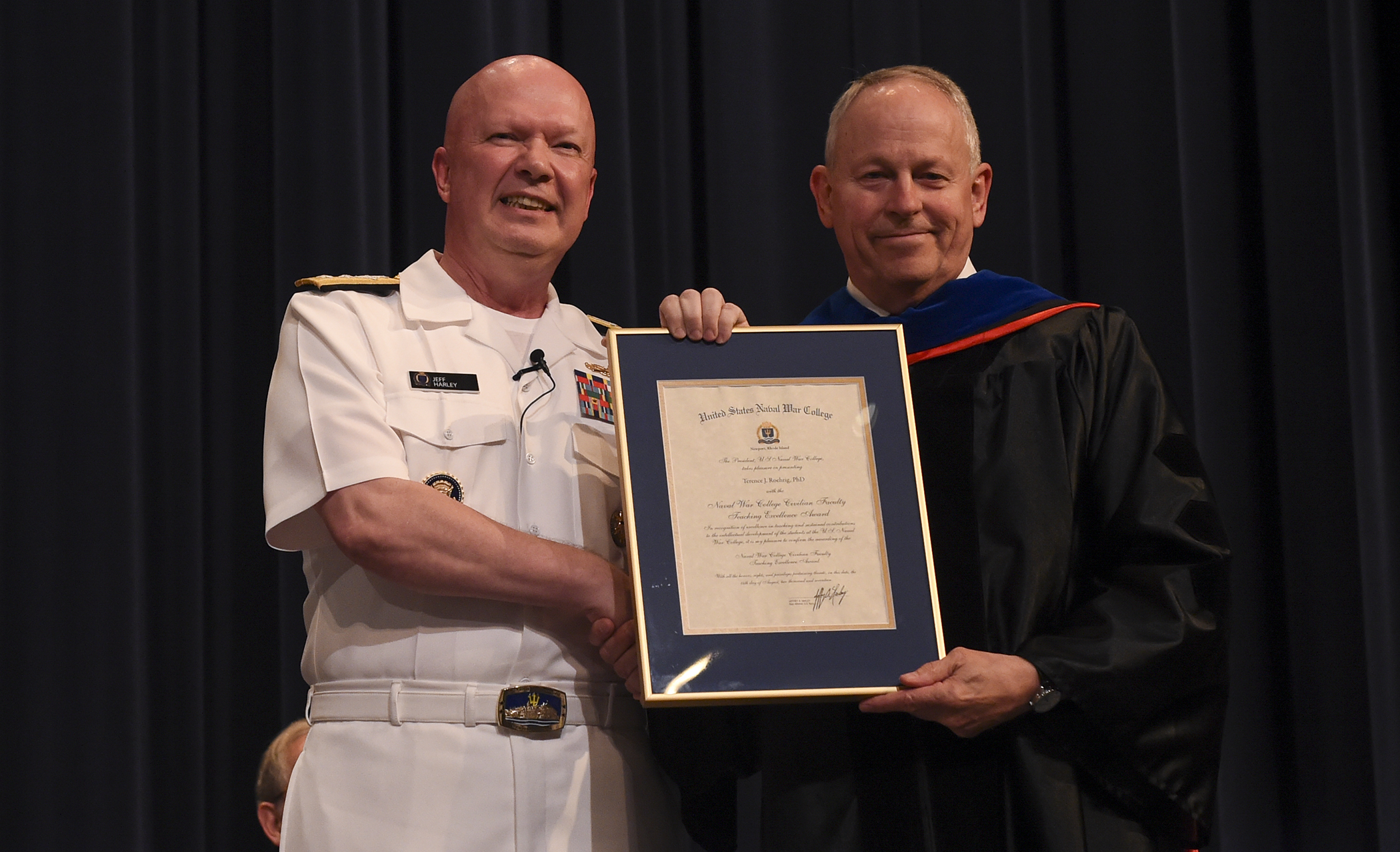 Rear Adm. Jeffrey A. Harley, president, U.S. Naval War College (NWC), presents a NWC Civilian Faculty Teaching Excellence Award to Terence J. Roehrig, professor, NWC’s National Security Affairs department. 
