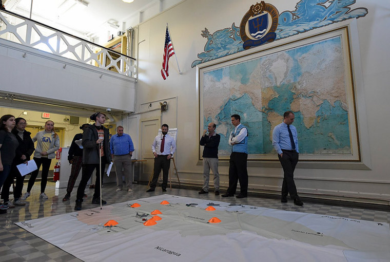 (March 26, 2018) U.S. Naval War College (NWC) faculty members along with students from the Massachusetts Institute of Technology (MIT) participate in a humanitarian response and disaster relief aid simulation during the MIT students’ visit to NWC’s Sims Hall. 