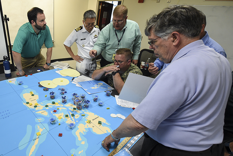 Military officers from various countries participate in the first international wargaming course.