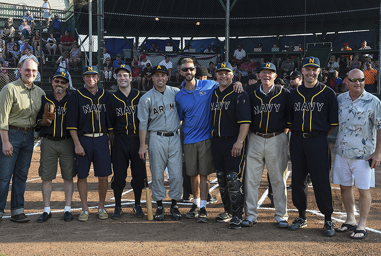 Members of the replicated historic Army and Navy baseball teams stand with Michael Falcone (center), the director of baseball operations at Cardines Field following a ceremonial first pitch to commemorate and honor a historic baseball game which took place in London 100 years ago. 