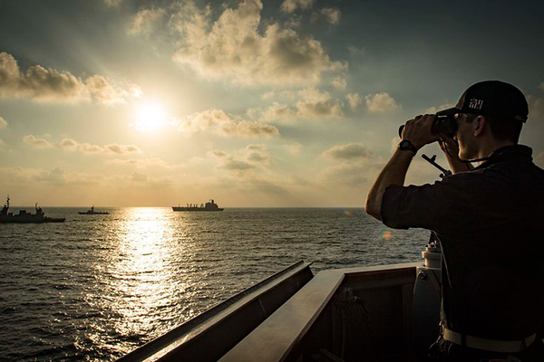 Ensign Jordan Whittle observes the Israeli Navy Sa’ar 5-class corvette INS Lahav.
