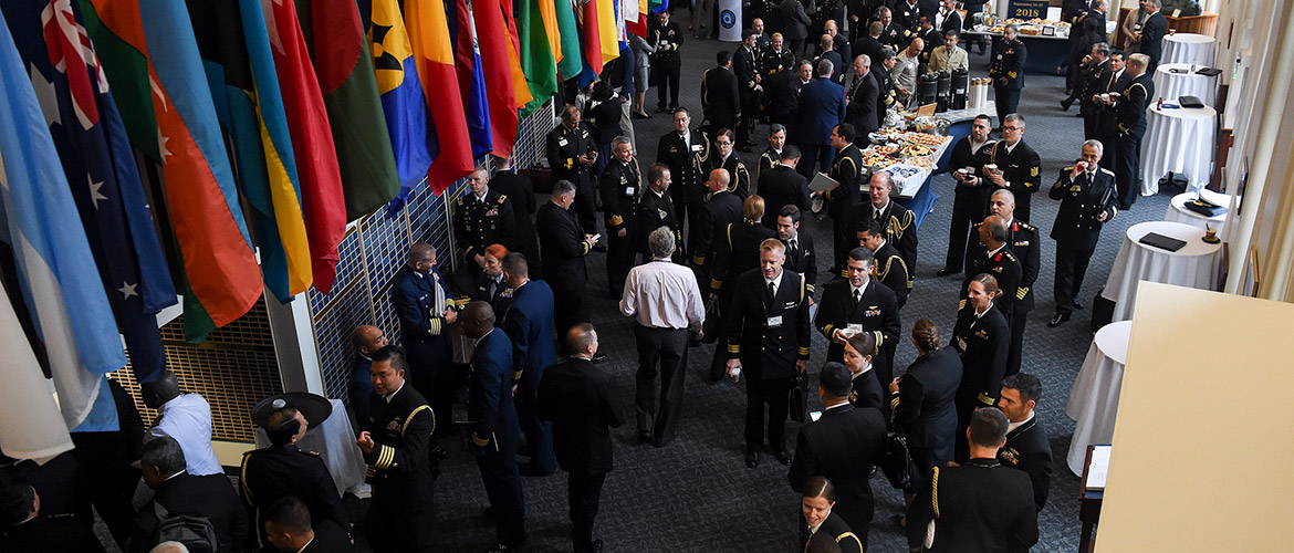 Participants converse during the Chief of Naval Operations' 23rd International Seapower Symposium (ISS) at U.S. Naval War College.