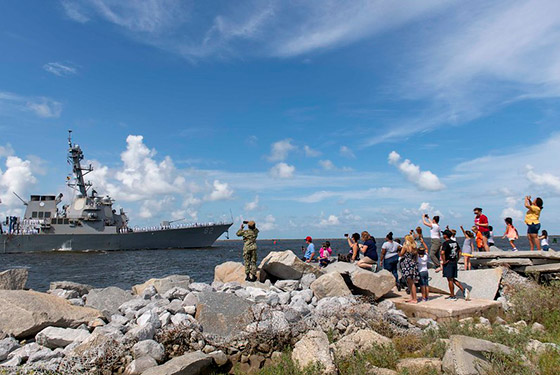  Families wave as the Arleigh Burke-class guided-missile destroyer USS Lassen (DDG 82) departs Naval Station Mayport.
