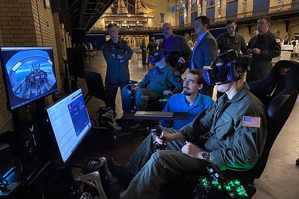 A U.S. Naval Academy midshipman conducts a simulated T-6B Texan II flight on a newly installed virtual reality trainer at the U.S. Naval Academy during aviation selection night at Dahlgren Hall.
