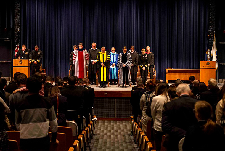 Cmdr. Robert Nelson, chaplain, gives the benediction during a U.S. Naval War College graduation ceremony, March 3. 
