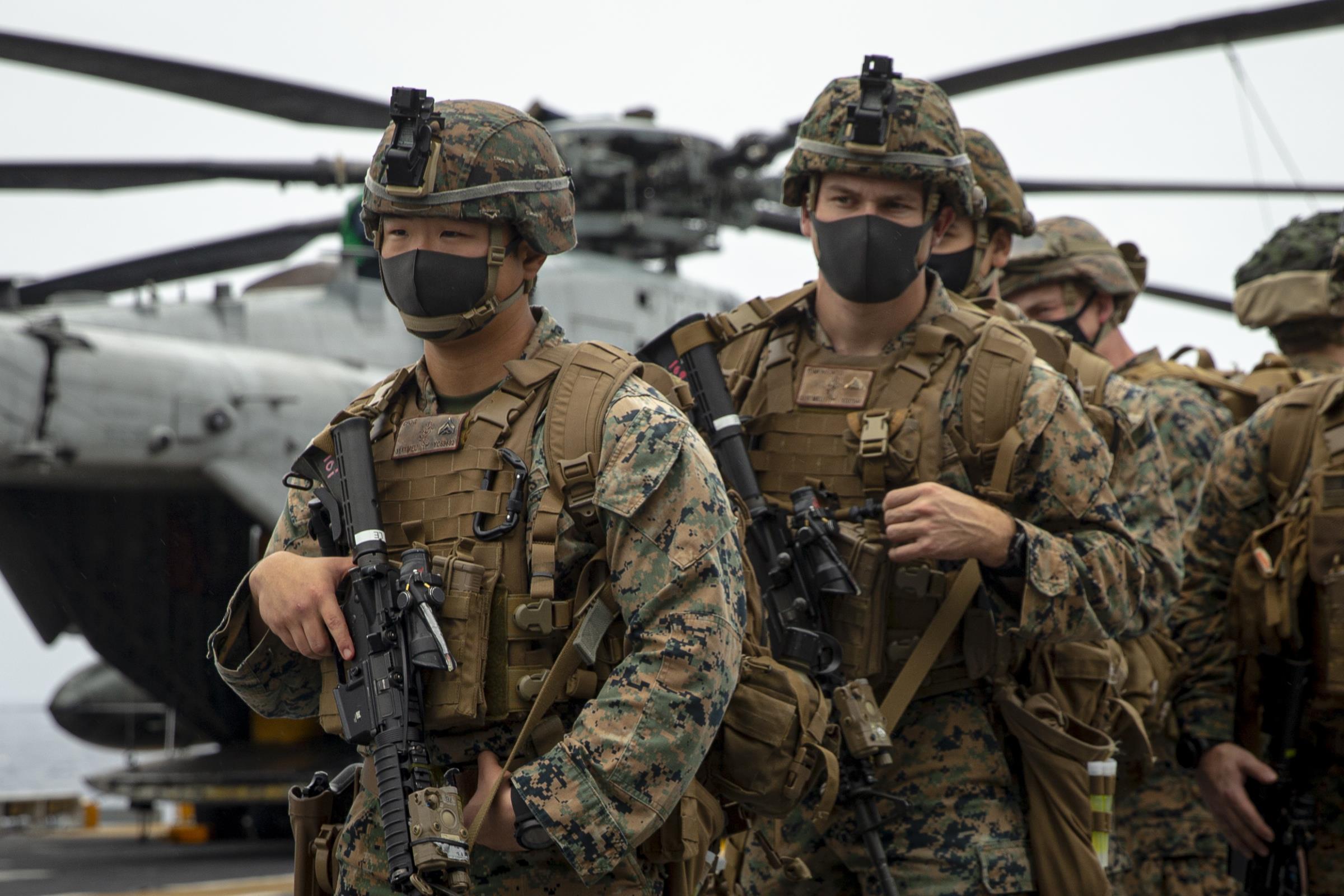 EAST CHINA SEA (Jan. 21, 2021) U.S. Marines with Battalion Landing Team, 3rd Battalion, 4th Marines, 31st Marine Expeditionary Unit (MEU) stand by to conduct training aboard the amphibious assault ship USS America (LHA 6) in the East China Sea, Jan. 21, 2021.