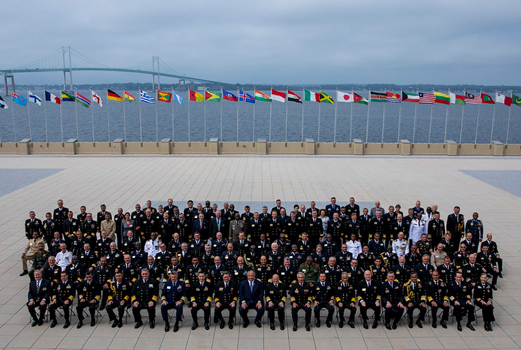 International delegates, including the U.S Secretary of the Navy and heads of navies and coast guards pose for a photo during the 24th International Seapower Symposium.