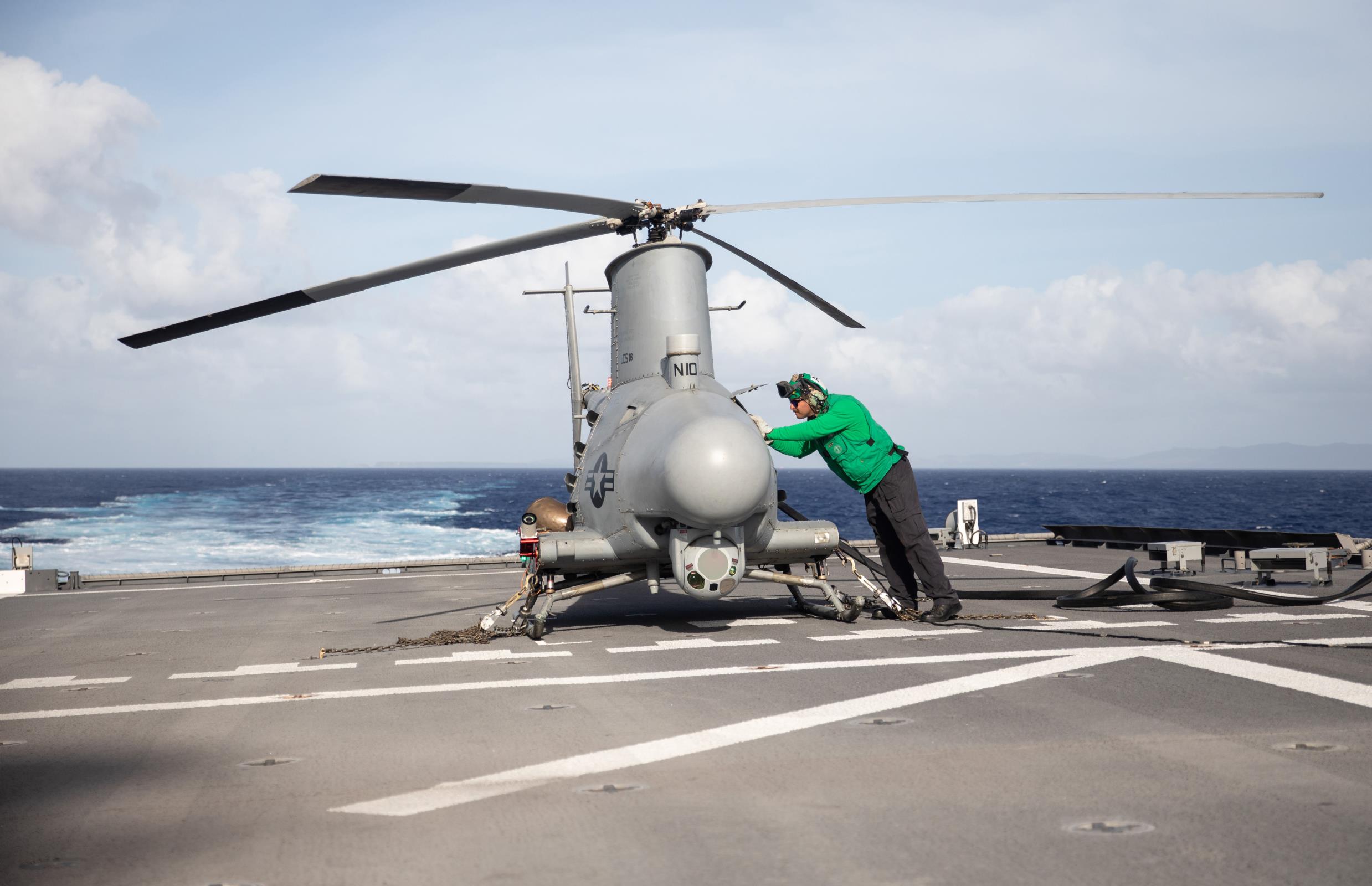 PHILIPPINE SEA (Feb. 14, 2022) Aviation Electronics Technician 2nd Class Joshua Trevino, from Victoria, Texas, assigned to the “Blackjacks” of Helicopter Sea Combat Squadron (HSC) 21, conducts a pre-flight check on an MQ-8B Fire Scout unmanned aerial vehicle aboard the Independence-variant littoral combat ship USS Tulsa (LCS 16).