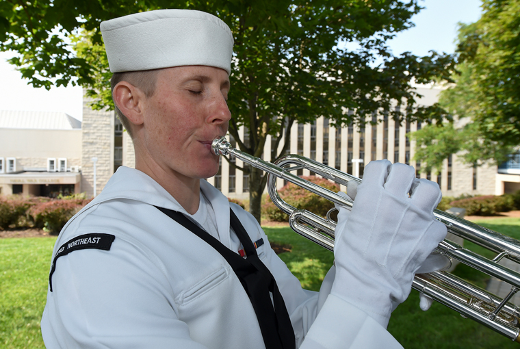 Photo of Musician 3rd Class Alicia Sowders playing Taps.