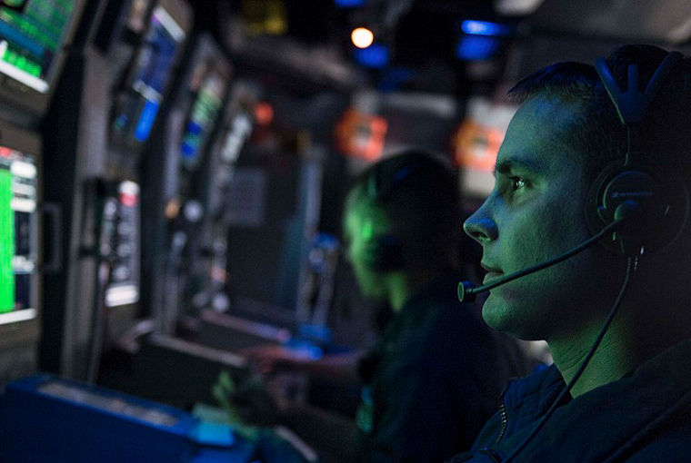 Photo of a sailor standing watch in the combat information center during a anti-submarine warfare exercise aboard the Ticonderoga-class guided-missile cruiser USS Chancellorsville (CG 62).