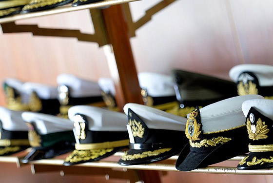 Combination covers representative of several international navies and coast guards sit on display at NWC's 14th Regional Alumni Symposium held at the Peruvian Naval Academy in LaPunta-Callao, Peru. 