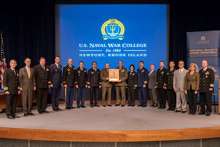 Rear Adm. Jeffrey A. Harley (right), president, U.S. Naval War College (NWC), presents the James V. Forrestal Award for Excellence in Force Planning to top graduates of the 2017 National Security Decision Making (NSDM) course.