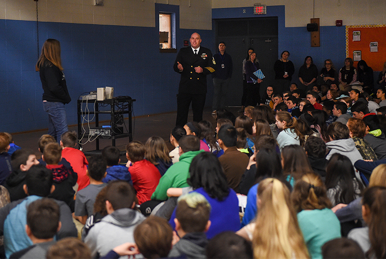 Senior Chief Boatswain’s Mate Herb Kresge Jr., assigned to U.S. Naval War College in Newport, Rhode Island, and his daughter, Sierra Kresge, give a presentation to students and teachers at Gaudet Middle School in Middletown in support of the Month of the Military Child.